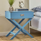 A blue nightstand with a clock and an open book resting on it, creating a cozy bedside scene.